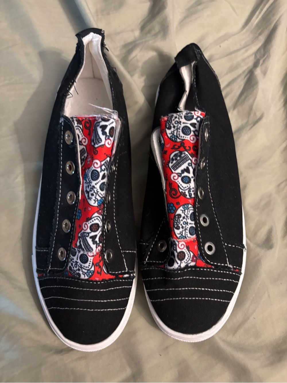Women’s Black Canvas Slip-On Sneakers with Red Sugar Skull Accent